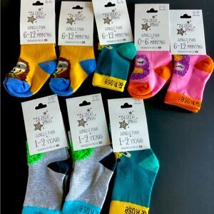 8 pairs of kids character socks. Owls, sloths, bees, hedgehogs.  Various sizes.